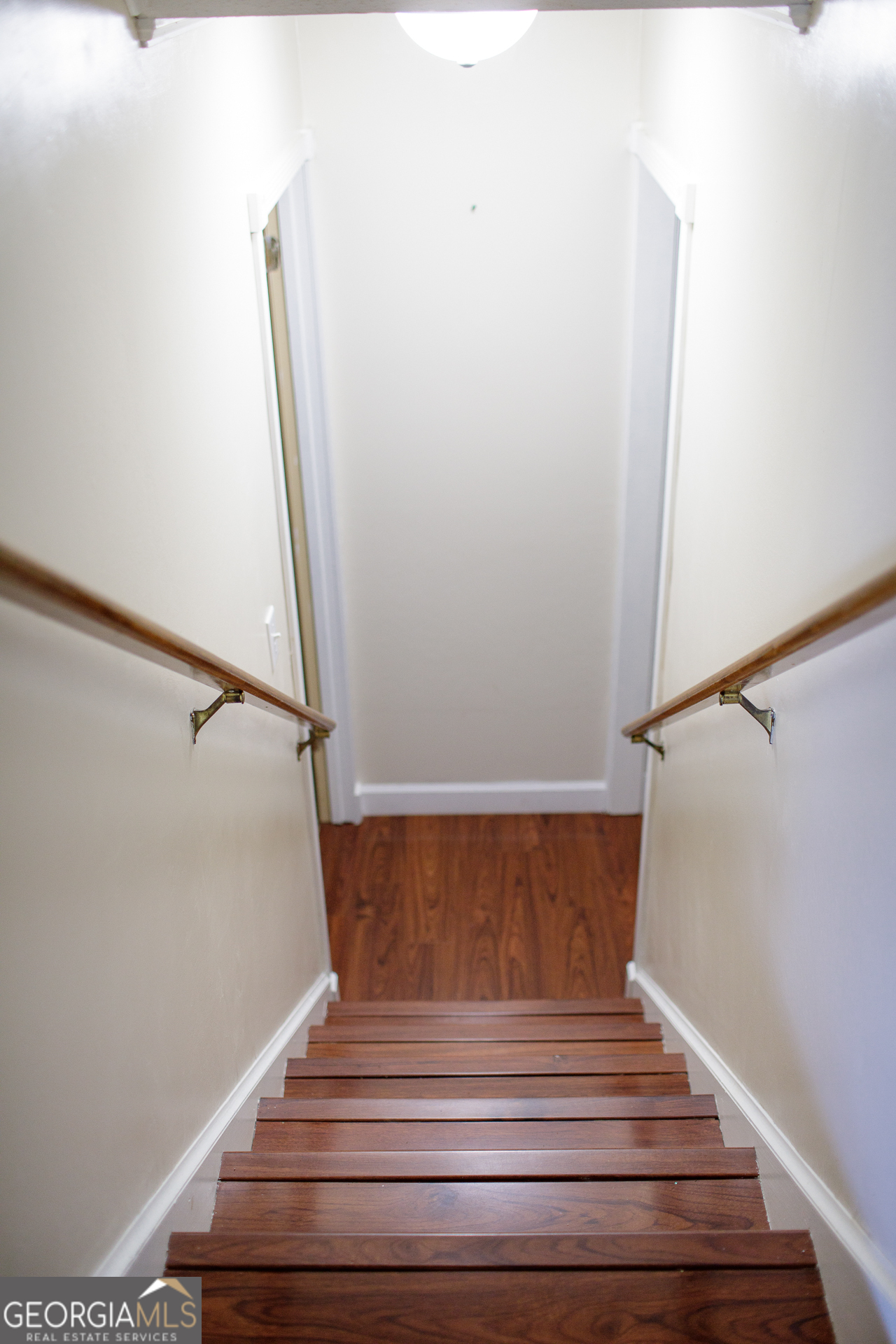 2110 Ware Street Blackshear, GA 31516 - Photo 25 of 57 a view of staircase with white walls and railing