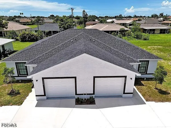 a view of house with yard and ocean view