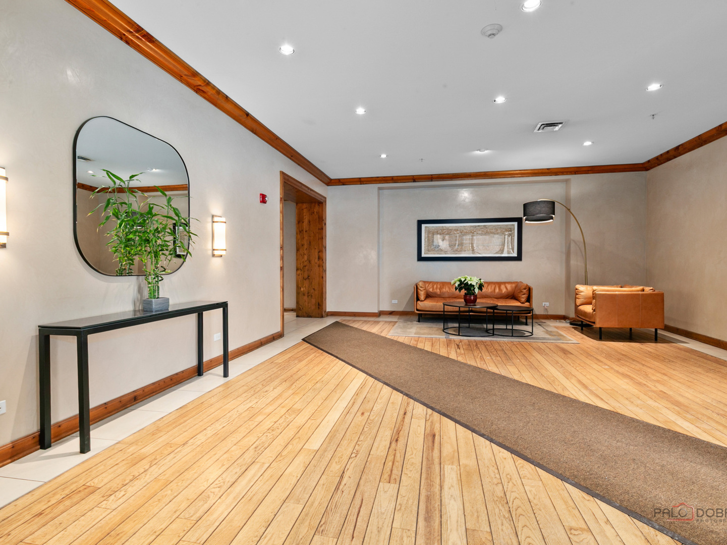 3535 Patten Road, Unit 6E Highland Park, IL 60035 - Photo 41 of 47 a spacious bedroom with a bed a dresser and potted plants with wooden floor