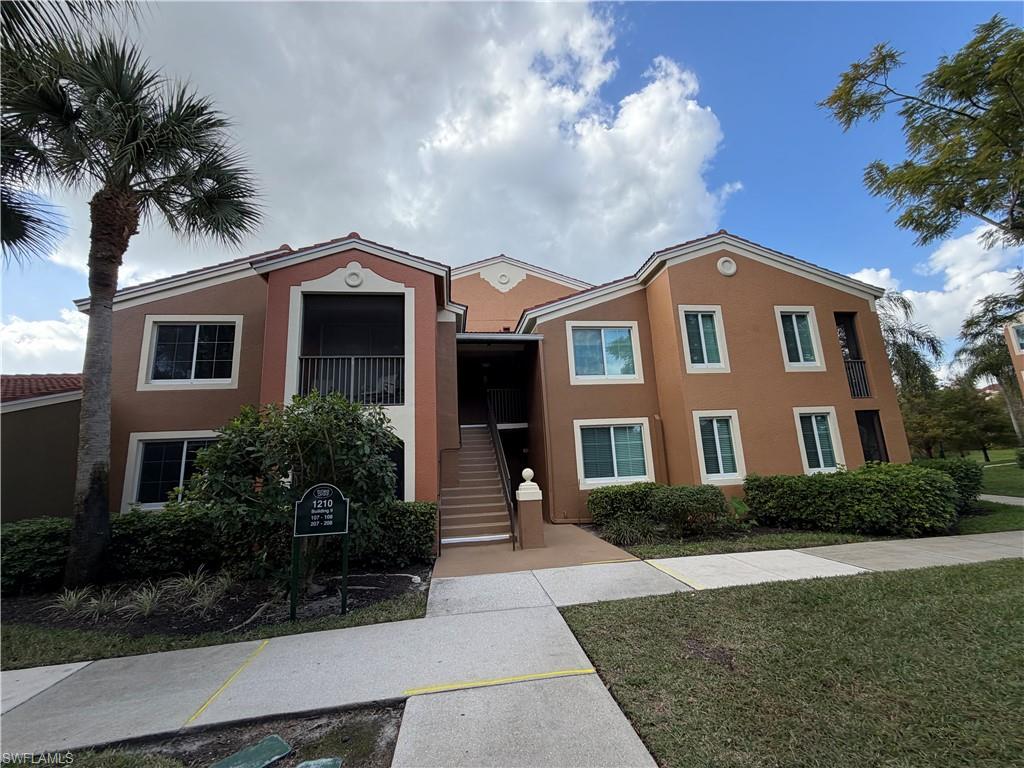 1210 Reserve Way, Unit 9107 Naples, FL 34105 - Photo 1 of 22 a front view of a house with garden