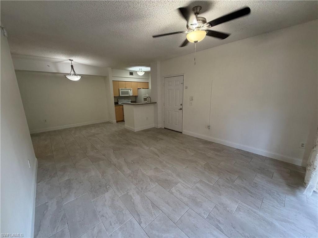 1210 Reserve Way, Unit 9107 Naples, FL 34105 - Photo 3 of 22 a view of a livingroom with a ceiling fan window and a ceiling fan