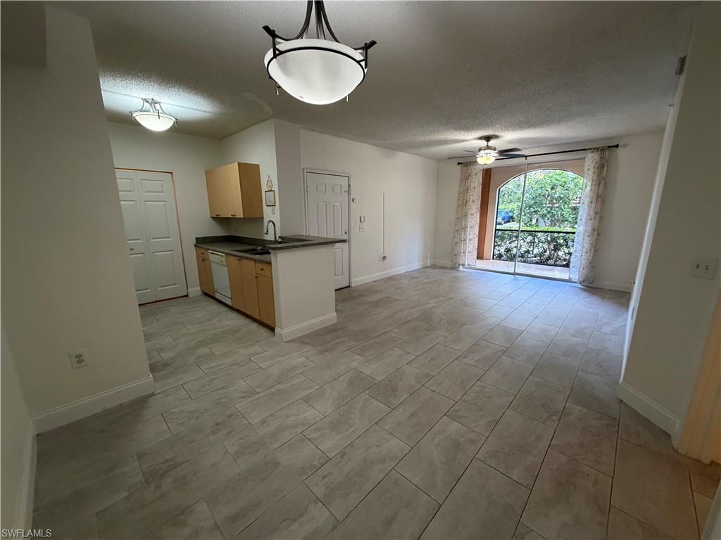 1210 Reserve Way, Unit 9107 Naples, FL 34105 - Photo 5 of 22 a view of a kitchen with a sink and a window