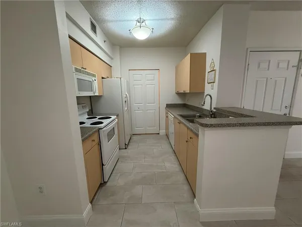 a kitchen with a sink stove and refrigerator