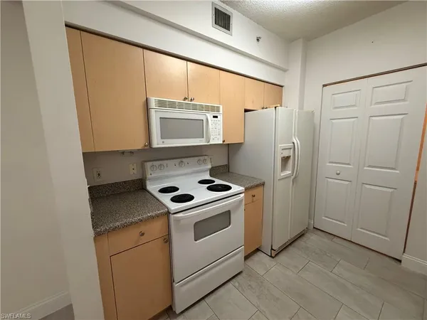 a kitchen with a stove microwave and refrigerator