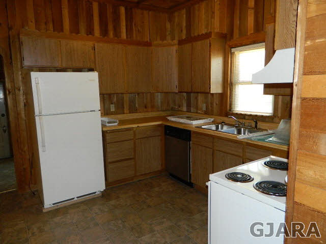 2398 H Road Grand Junction, CO 81505 - Photo 7 of 7 a kitchen with a sink a stove and a refrigerator