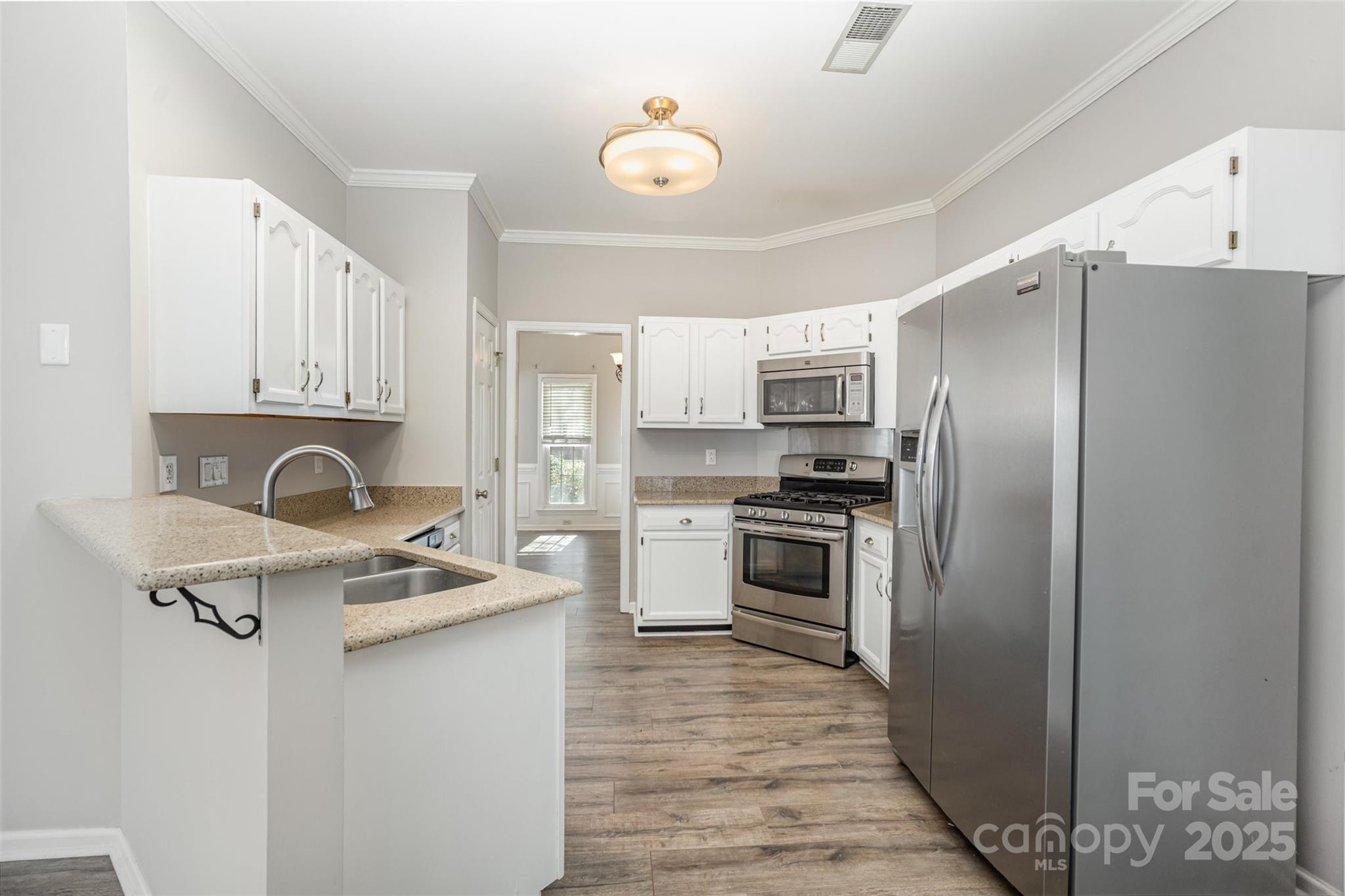 2507 Bathgate Lane Matthews, NC 28105 - Photo 11 of 36 a kitchen with stainless steel appliances granite countertop a refrigerator stove and sink