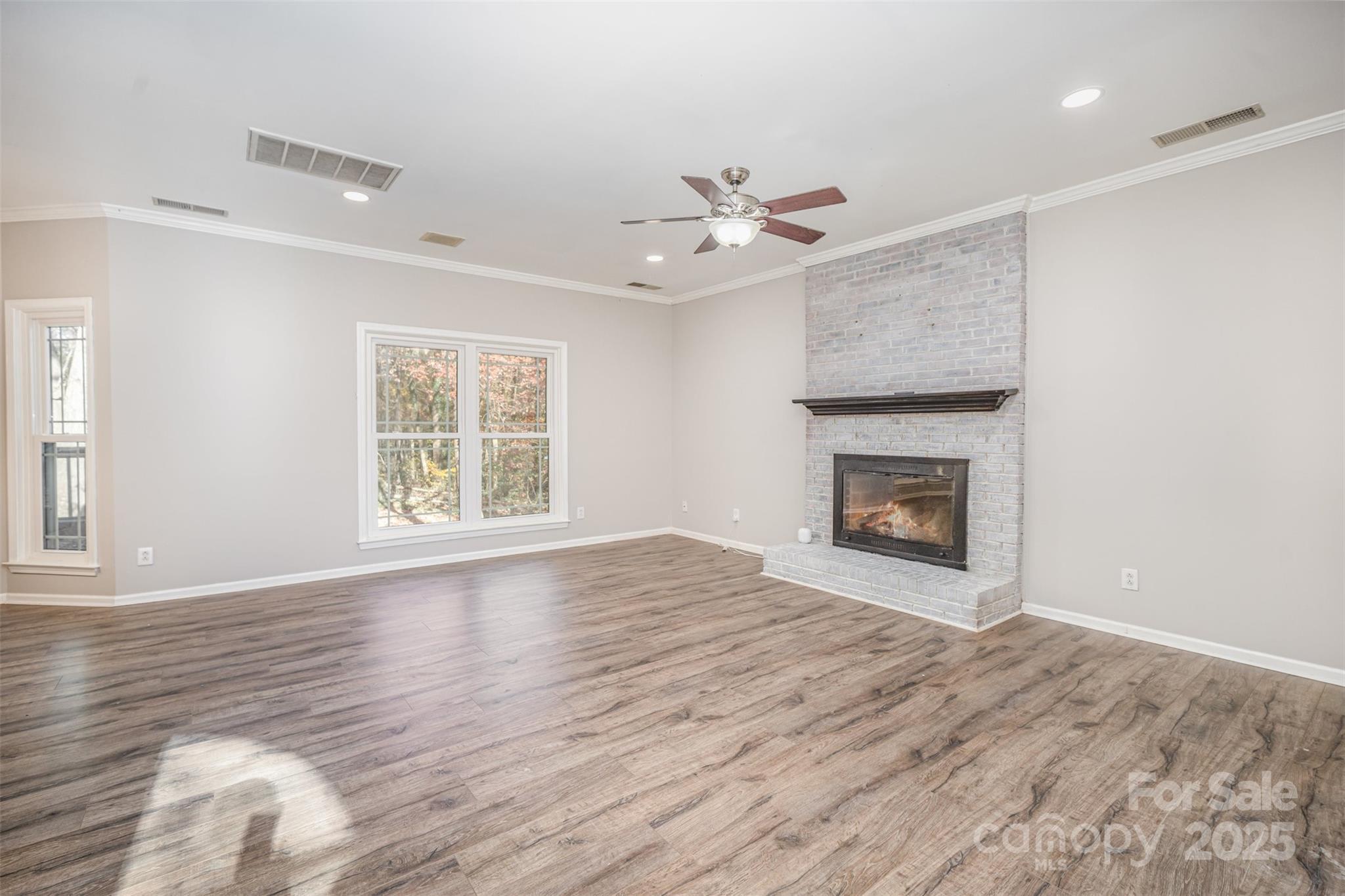 2507 Bathgate Lane Matthews, NC 28105 - Photo 14 of 36 an empty room with windows fireplace and a sink