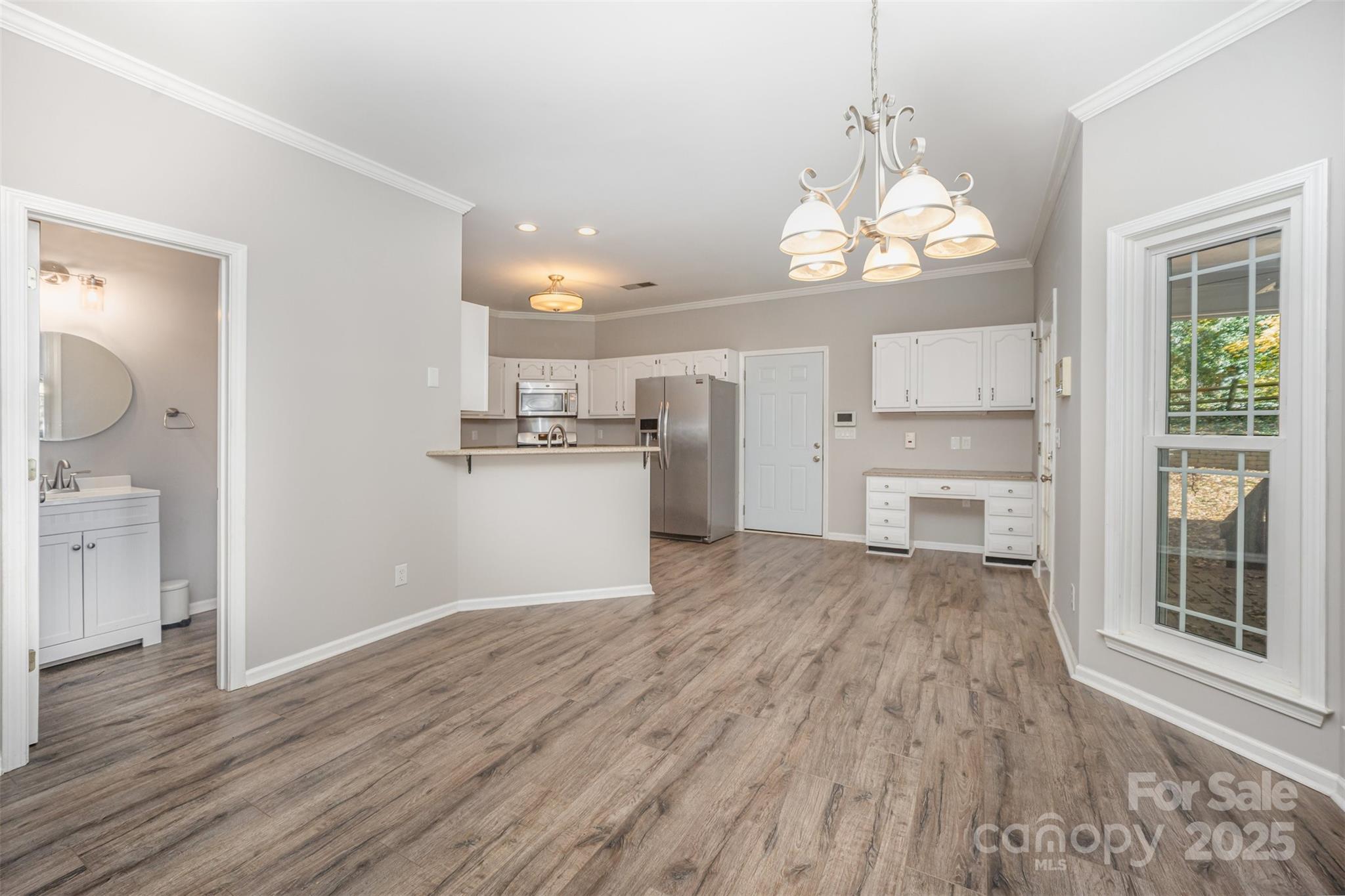 2507 Bathgate Lane Matthews, NC 28105 - Photo 15 of 36 a view of a kitchen with wooden floor and a window
