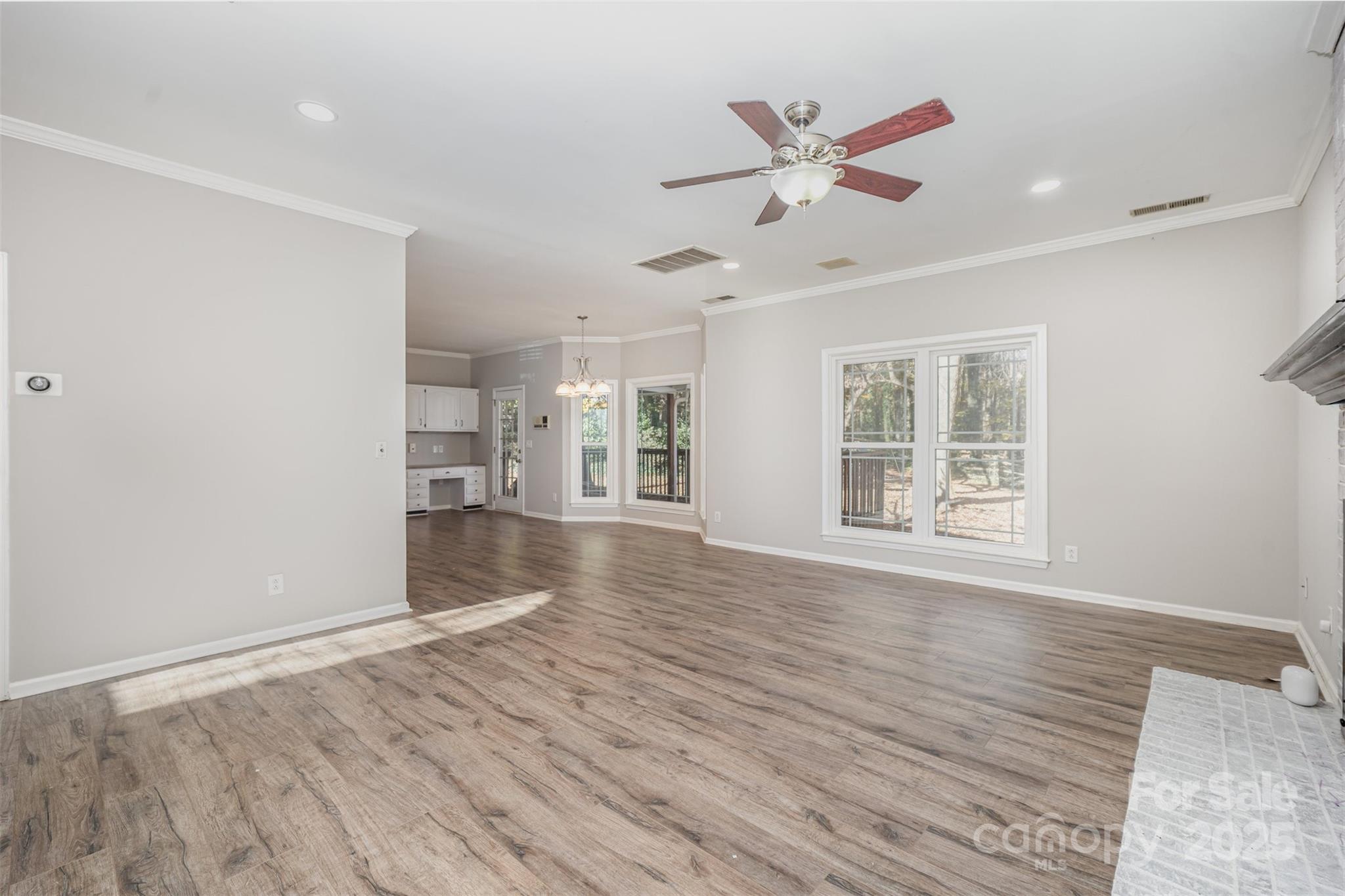 2507 Bathgate Lane Matthews, NC 28105 - Photo 17 of 36 a view of an empty room with wooden floor and a window