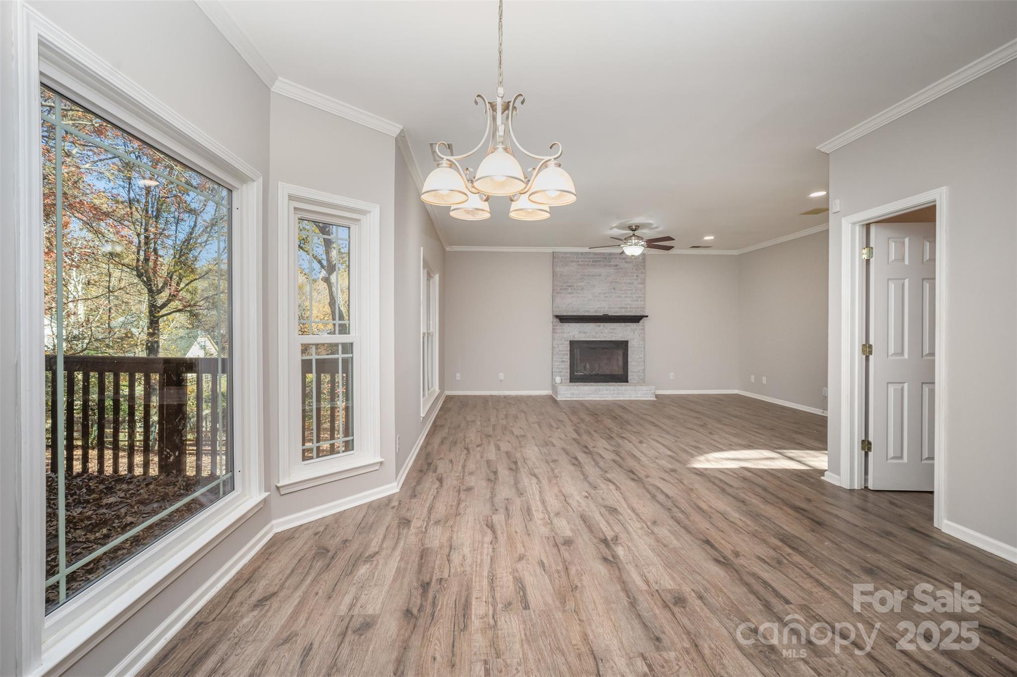 2507 Bathgate Lane Matthews, NC 28105 - Photo 18 of 36 a view of a livingroom with wooden floor and a ceiling fan