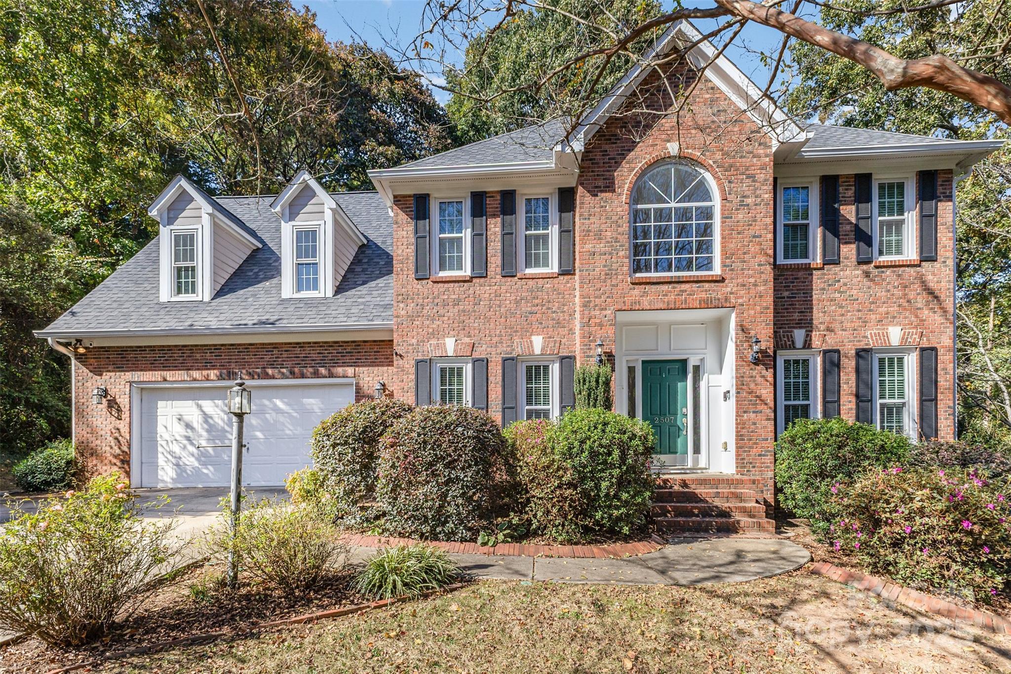 2507 Bathgate Lane Matthews, NC 28105 - Photo 30 of 36 a front view of a house with garden