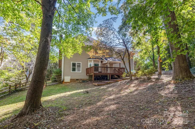 a view of a house with a tree and a yard