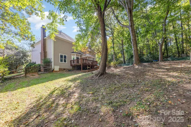 a view of backyard of house with green space