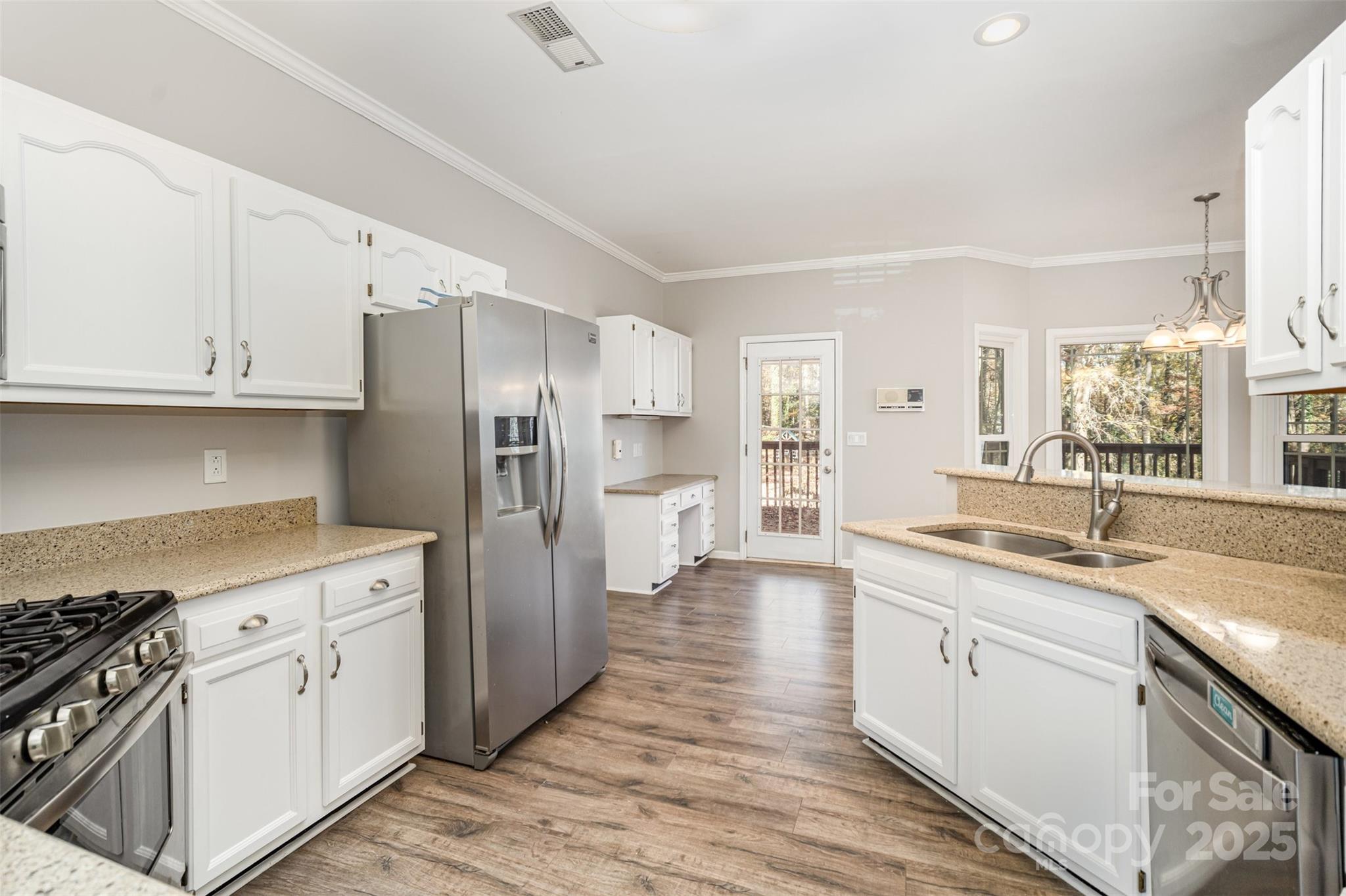 2507 Bathgate Lane Matthews, NC 28105 - Photo 4 of 36 a kitchen with stainless steel appliances granite countertop a stove a sink and a refrigerator
