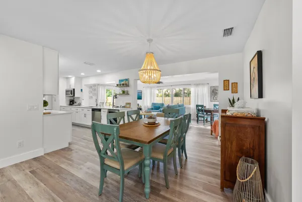 a living room with furniture and a view of kitchen