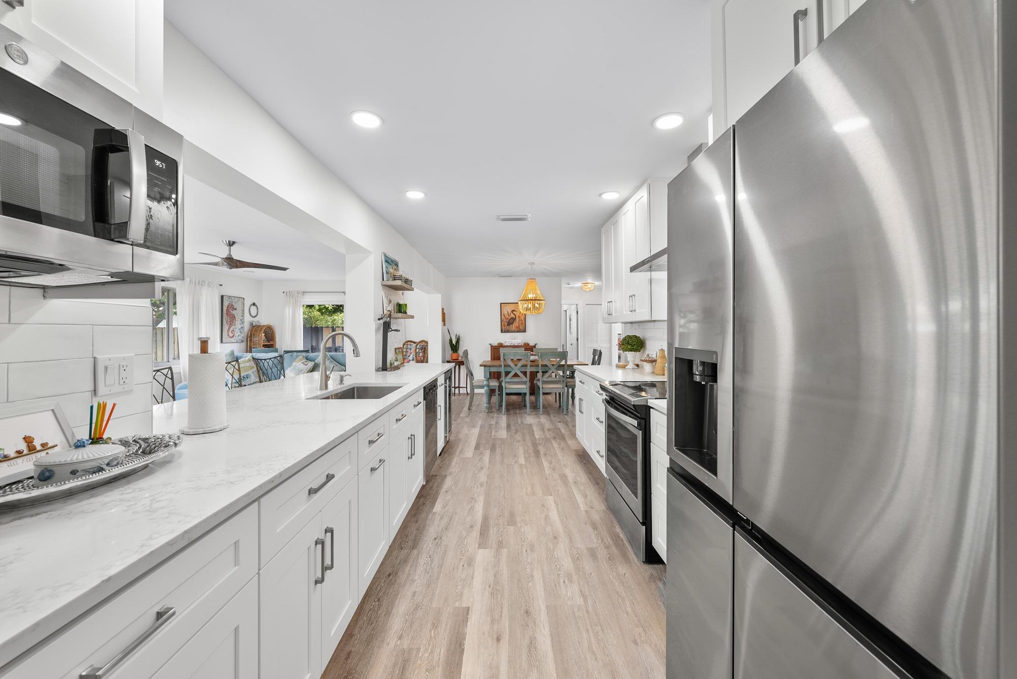 517 Gulf Road North Palm Beach, FL 33408 - Photo 13 of 59 a large kitchen with stainless steel appliances lots of counter top space