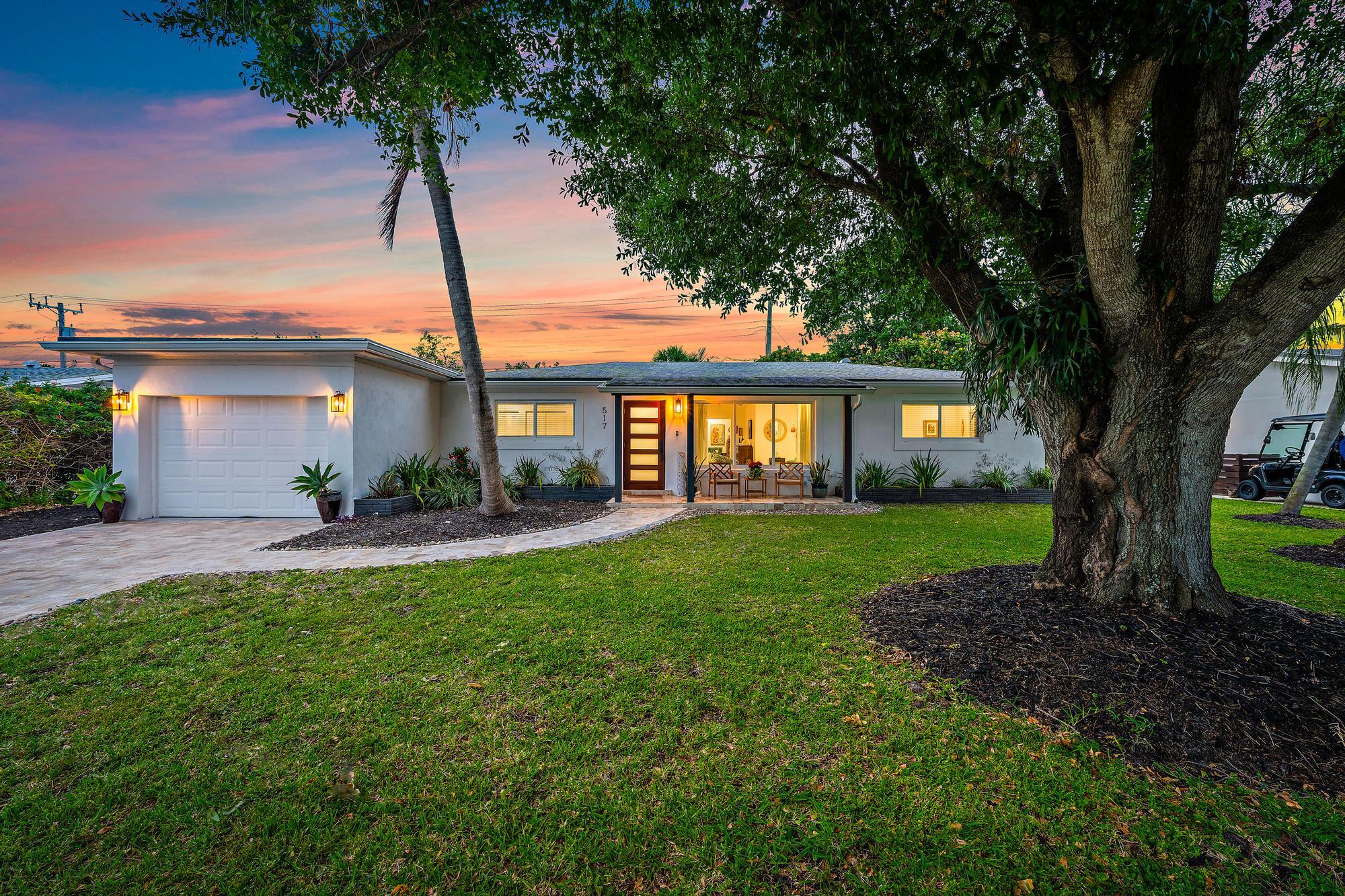 517 Gulf Road North Palm Beach, FL 33408 - Photo 2 of 59 a front view of a house with a garden and patio