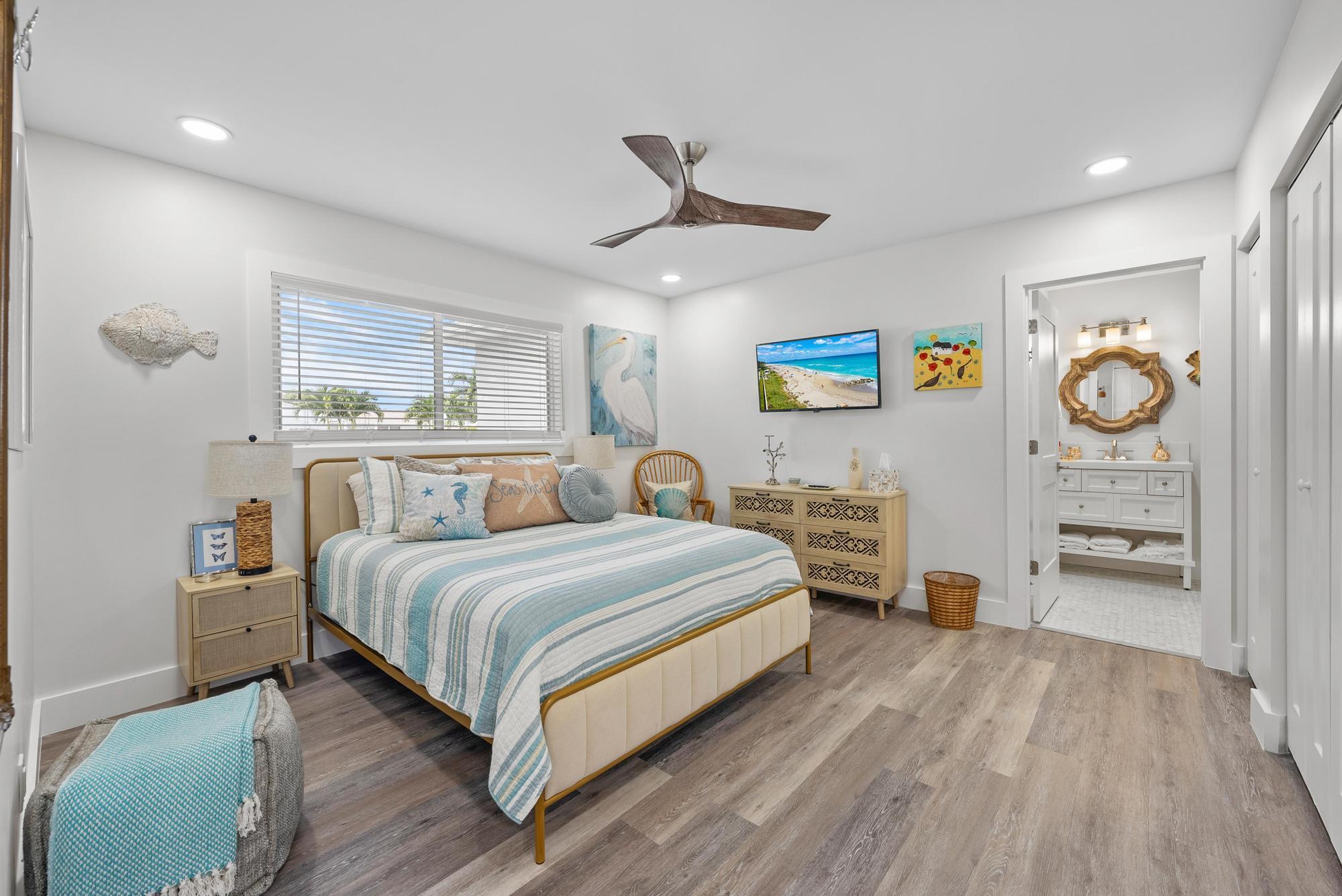 517 Gulf Road North Palm Beach, FL 33408 - Photo 21 of 59 a bedroom with a bed and ceiling fan