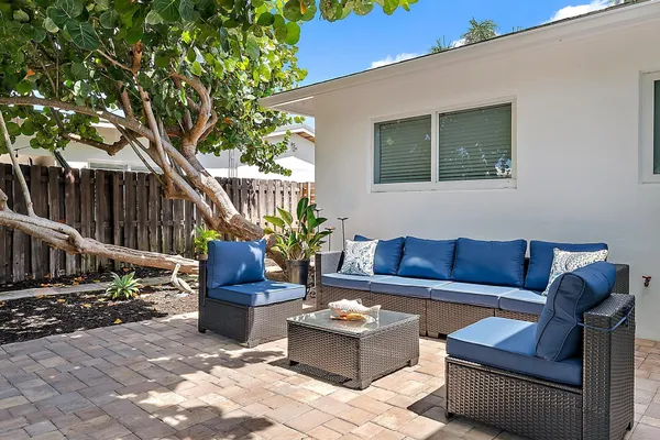 a view of a house with a yard and sitting area
