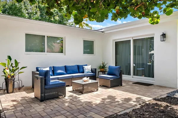 a view of a chair and table in backyard of the house