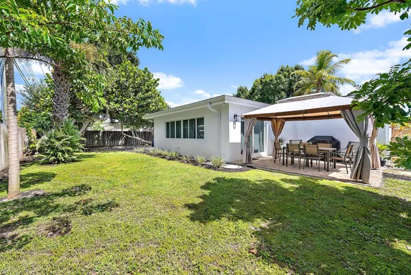a view of table and chair with wooden fence