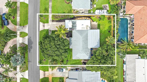 an aerial view of a residential houses with outdoor space and street view