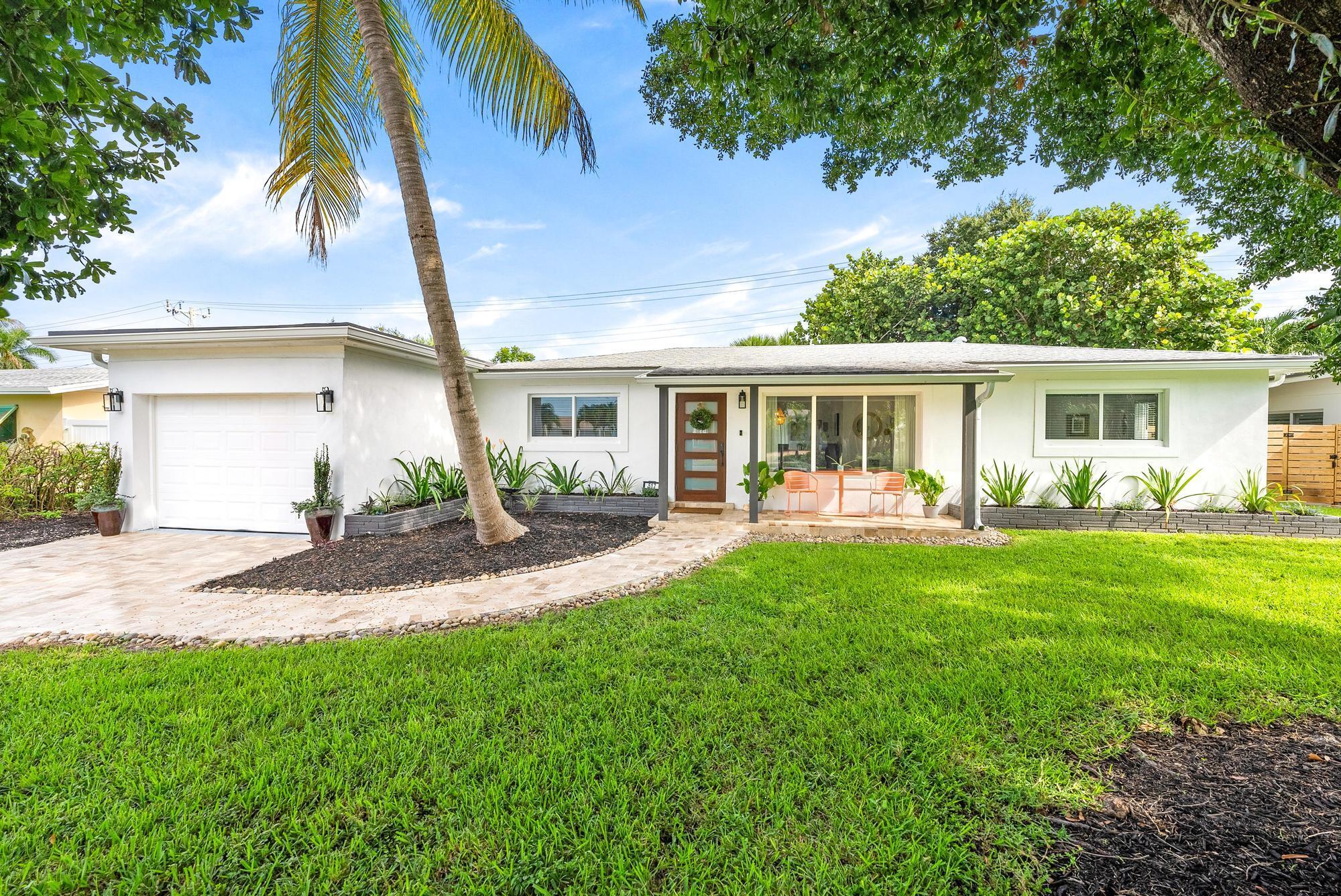 517 Gulf Road North Palm Beach, FL 33408 - Photo 4 of 59 a view of a house with a backyard and a patio