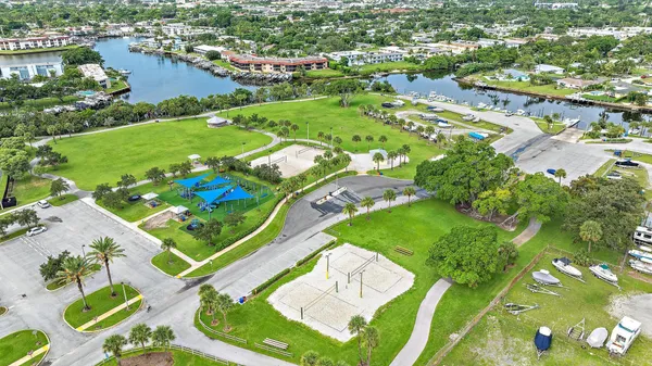 a view of a swimming pool with a lake view and trees in the background