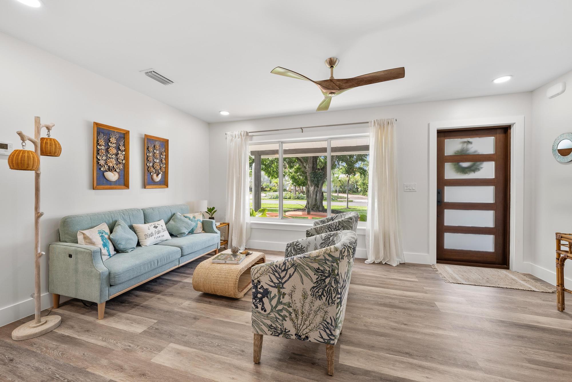 517 Gulf Road North Palm Beach, FL 33408 - Photo 9 of 59 a living room with furniture and a large window