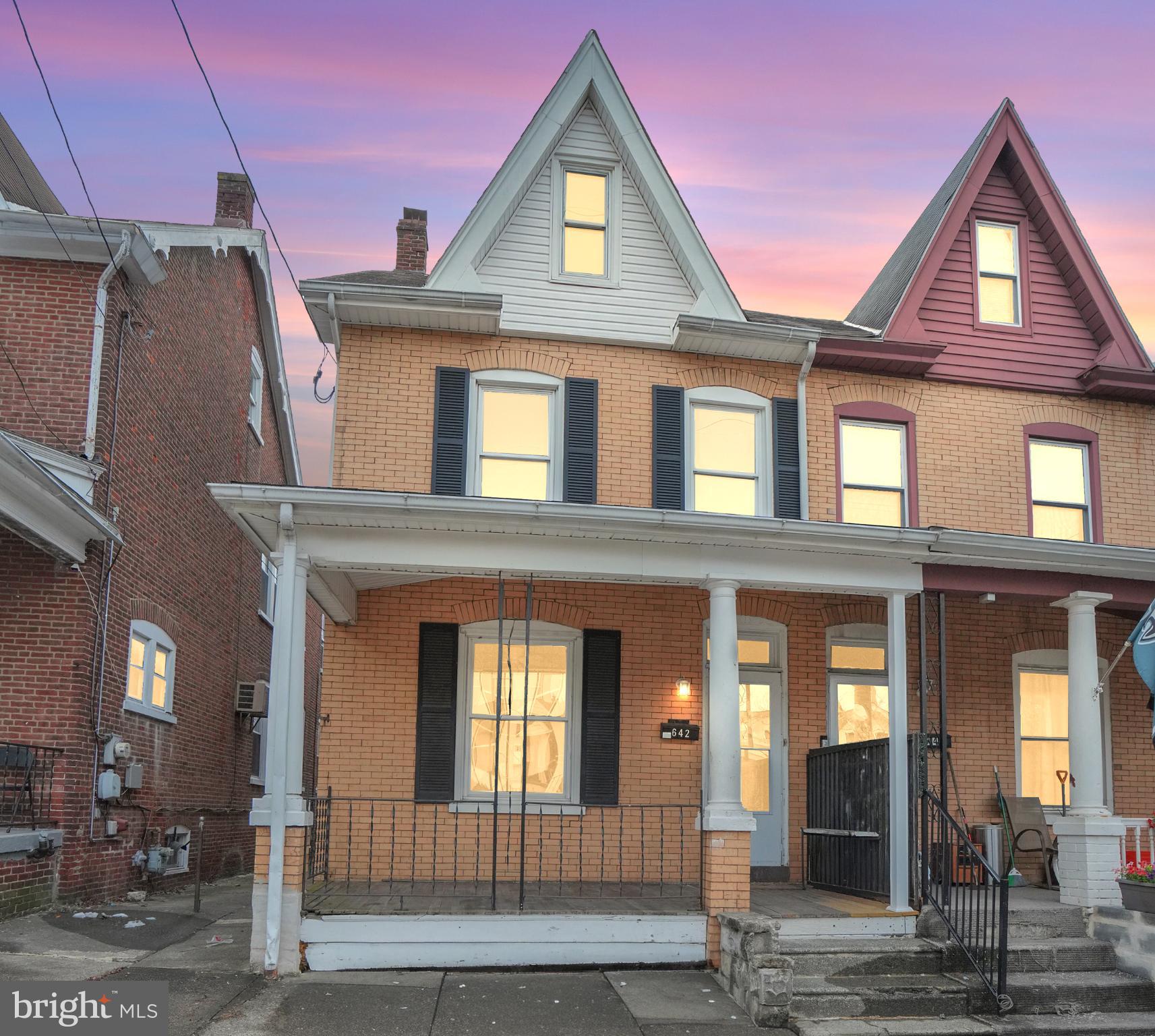 Charming brick home at sunset glow.