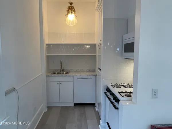 a kitchen with a sink and a stove top oven