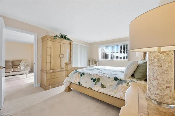 a bed room with a bed and a chair