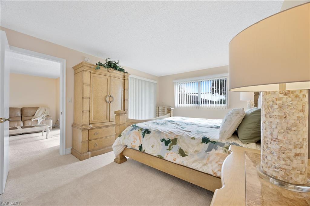 5683 Rattlesnake Hammock Road, Unit A202 Naples, FL 34113 - Photo 14 of 27 Primary bedroom
