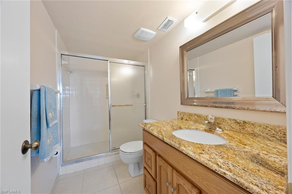 5683 Rattlesnake Hammock Road, Unit A202 Naples, FL 34113 - Photo 16 of 27 Updated cabinet with granite countertops shower.
