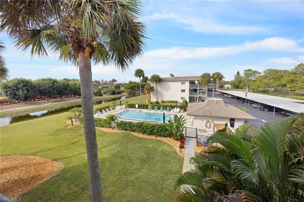 5683 Rattlesnake Hammock Road, Unit A202 Naples, FL 34113 - Photo 22 of 27 Community pool with a patio area