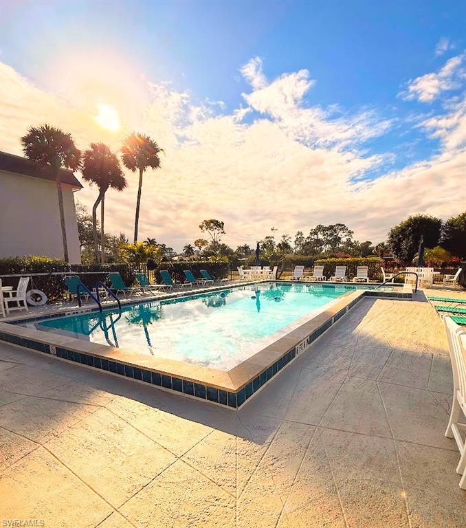 5683 Rattlesnake Hammock Road, Unit A202 Naples, FL 34113 - Photo 23 of 27 Community pool featuring a patio