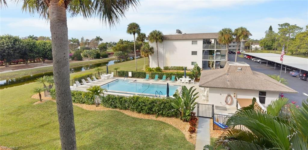 5683 Rattlesnake Hammock Road, Unit A202 Naples, FL 34113 - Photo 24 of 27 Community pool with a patio