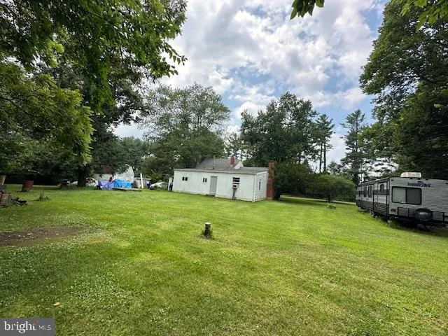 a house view with swimming pool and trees