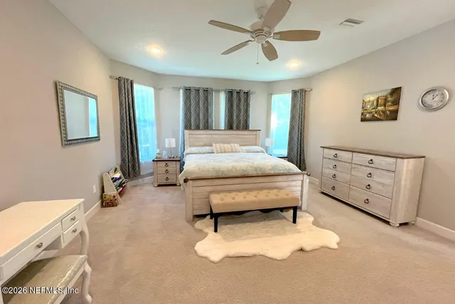 a bedroom with furniture and a chandelier