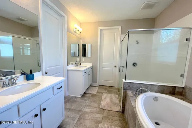 a bathroom with a tub sink a toilet and mirror