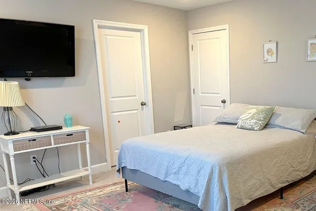 a bedroom with a bed and a flat screen tv
