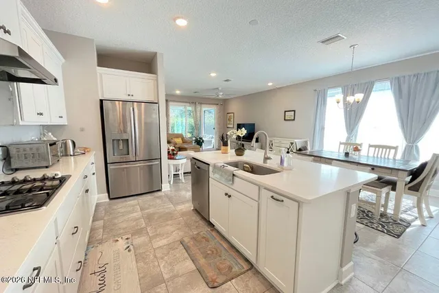 a kitchen with a sink appliances and cabinets