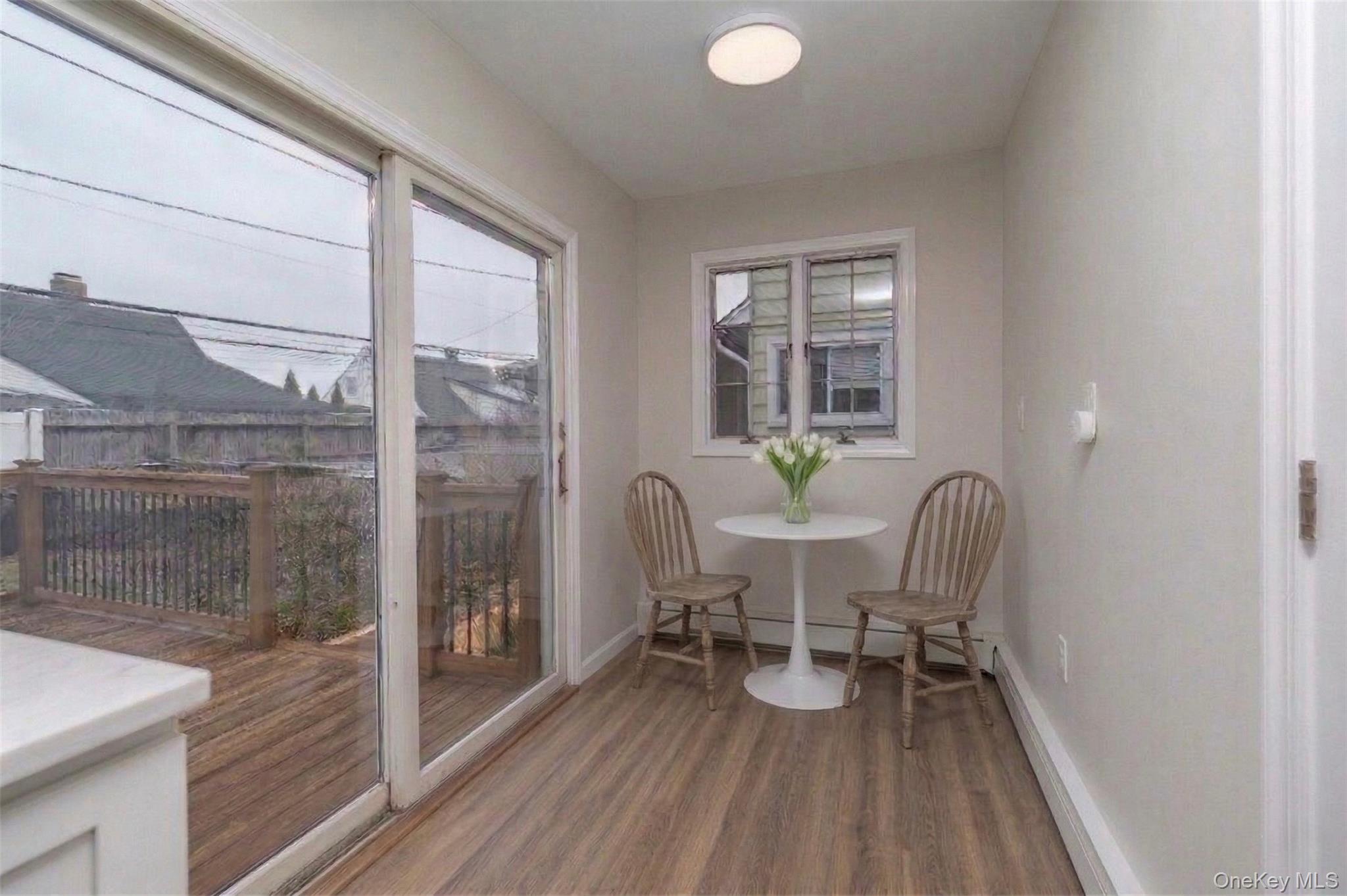 485 Farm Ranch Road West Bethpage, NY 11714 - Photo 12 of 26 Virtually Staged Eat-In Area In New Kitchen with High Hat Lights That Leads to Side Entrance Foyer and Basement
