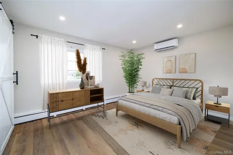 a spacious bedroom with a bed and a dresser
