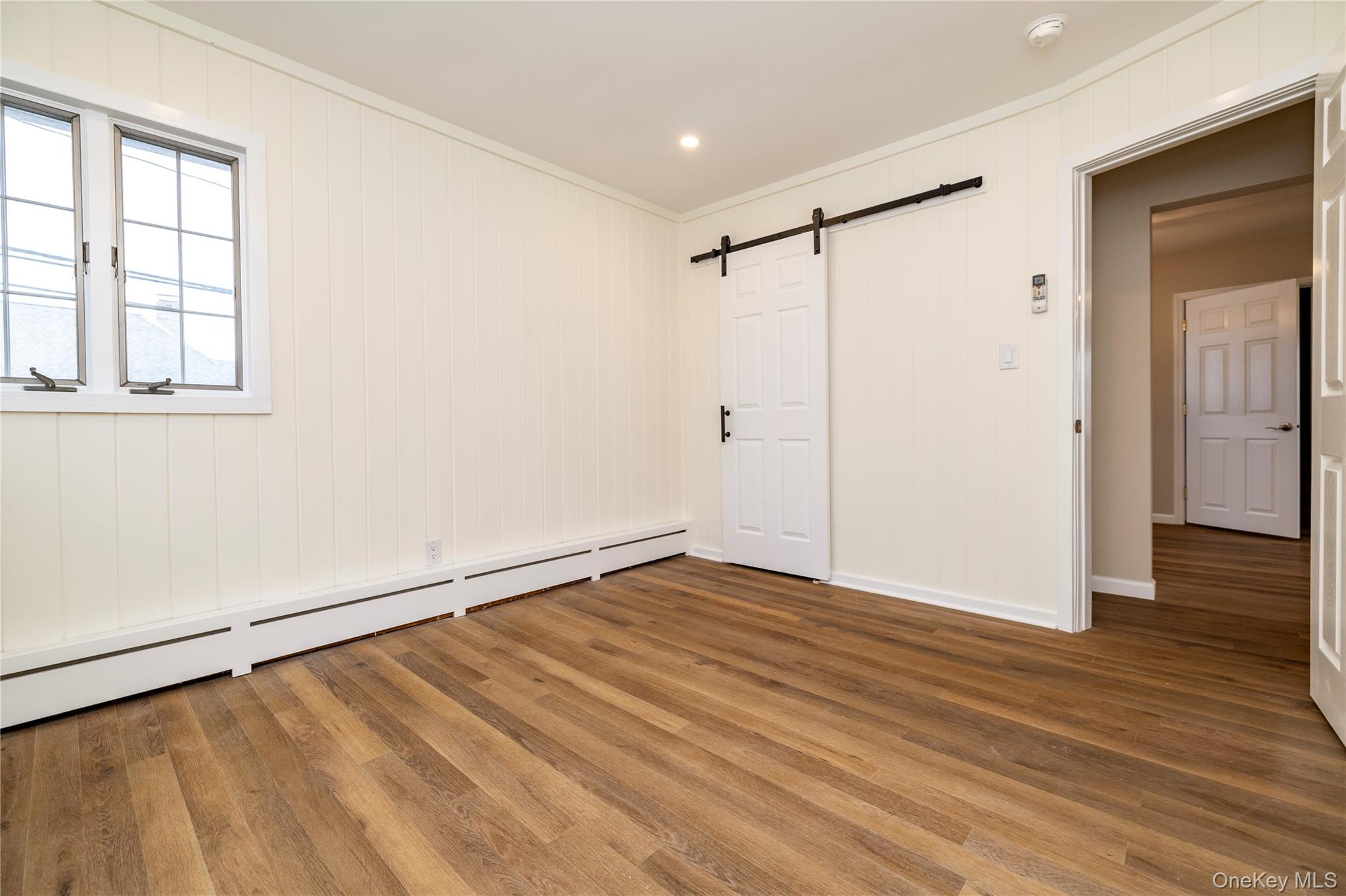 485 Farm Ranch Road West Bethpage, NY 11714 - Photo 17 of 26 Second Bedroom with New Vinyl Flooring, Freshly Painted Barn Door Closet.