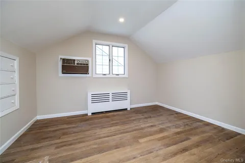 a view of wooden floor and windows in a room