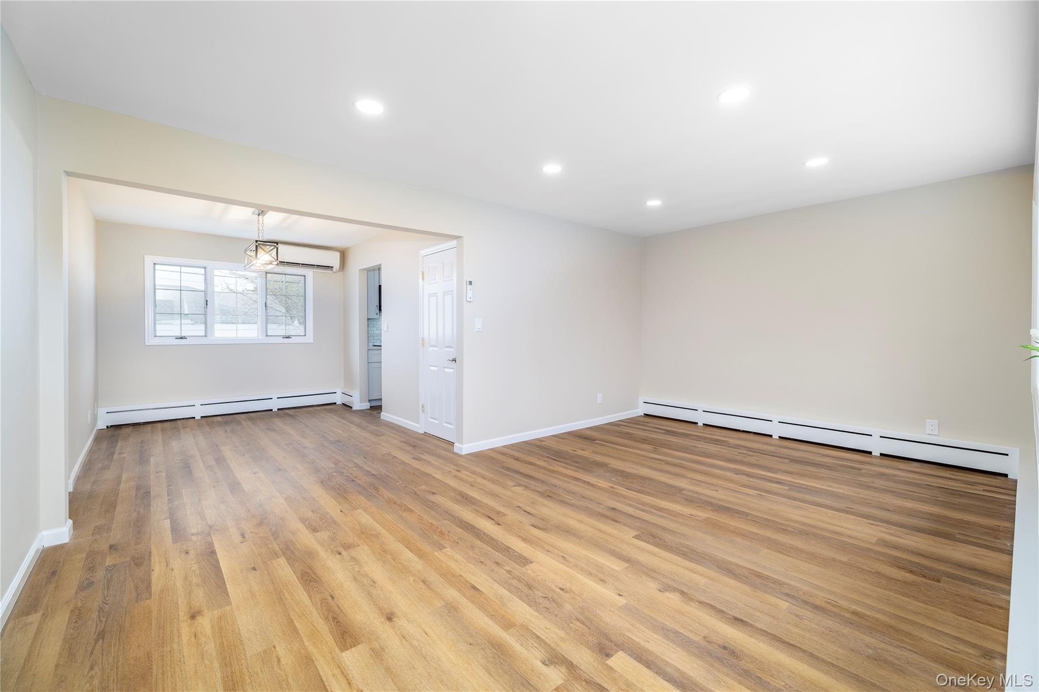 485 Farm Ranch Road West Bethpage, NY 11714 - Photo 6 of 26 Open Living Room/ Dining Room Fixture with Gorgeous New Vinyl Floors Throughout and Newly Painted