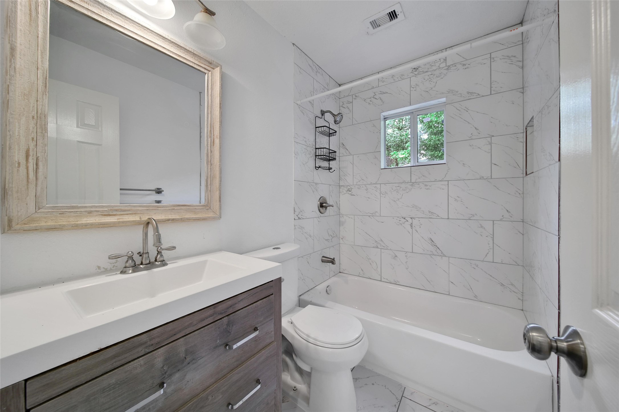 7346 Calais Road Houston, TX 77033 - Photo 8 of 9 a bathroom with a sink a toilet and shower