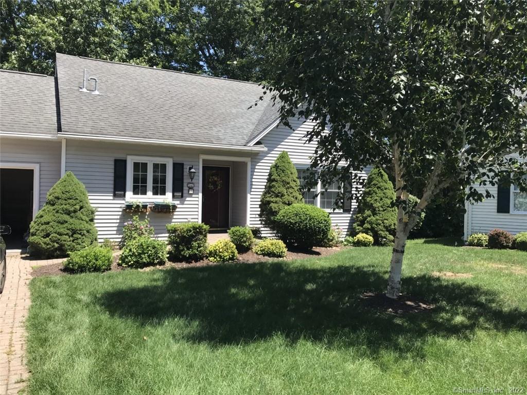 a view of a house with a garden and plants