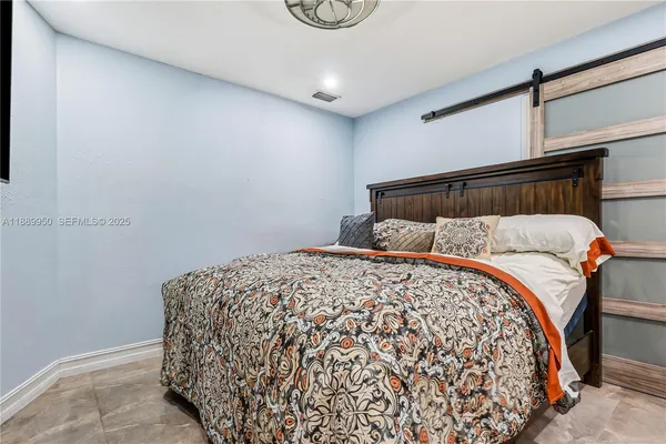 a bedroom with a bed and window